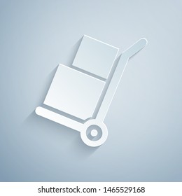 Paper cut Hand truck and boxes icon isolated on grey background. Dolly symbol. Paper art style. Vector Illustration