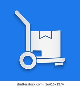 Paper cut Hand truck and boxes icon isolated on blue background. Dolly symbol. Paper art style. Vector Illustration