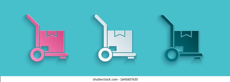 Paper cut Hand truck and boxes icon isolated on blue background. Dolly symbol. Paper art style. Vector Illustration