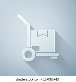 Paper cut Hand truck and boxes icon isolated on grey background. Dolly symbol. Paper art style. Vector Illustration