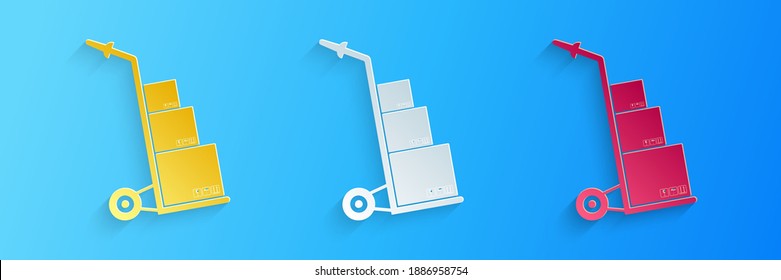 Paper cut Hand truck and boxes icon isolated on blue background. Dolly symbol. Paper art style. Vector.