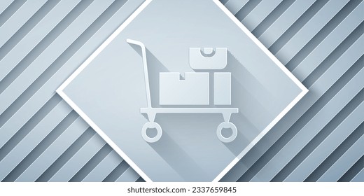 Paper cut Hand truck and boxes icon isolated on grey background. Dolly symbol. Paper art style. Vector