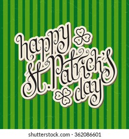 Paper cut hand written St. Patrick's day greetings over green stripes textured background.