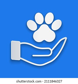 Paper cut Hands with animals footprint icon isolated on blue background. Pet paw in heart. Love to the animals. Paper art style. Vector