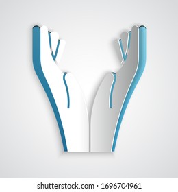 Paper cut Hands in praying position icon isolated on grey background. Prayer to god with faith and hope. Paper art style. Vector Illustration