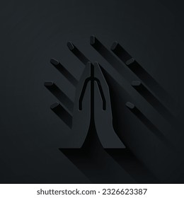 Paper cut Hands in praying position icon isolated on black background. Prayer to god with faith and hope. Paper art style. Vector