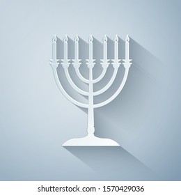 Paper cut Hanukkah menorah icon isolated on grey background. Religion icon. Hanukkah traditional symbol. Holiday religion, jewish festival of Lights. Paper art style. Vector Illustration