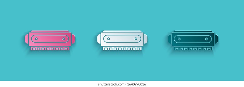 Paper cut Harmonica icon isolated on blue background. Musical instrument. Paper art style. Vector Illustration