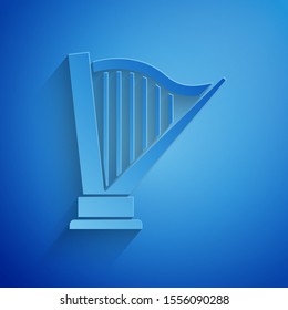 Paper cut Harp icon isolated on blue background. Classical music instrument, orhestra string acoustic element. Paper art style. Vector Illustration