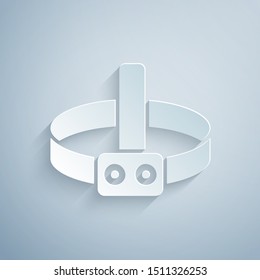 Paper cut Head flashlight icon isolated on grey background. Tourist head flashlight. Camping head light. Paper art style. Vector Illustration