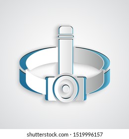 Paper cut Head flashlight icon isolated on grey background. Tourist head flashlight. Camping head light. Paper art style. Vector Illustration