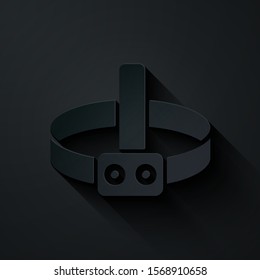 Paper cut Head flashlight icon isolated on black background. Tourist head flashlight. Camping head light. Paper art style. Vector Illustration