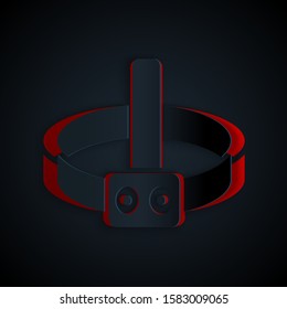 Paper cut Head flashlight icon isolated on black background. Tourist head flashlight. Camping head light. Paper art style. Vector Illustration