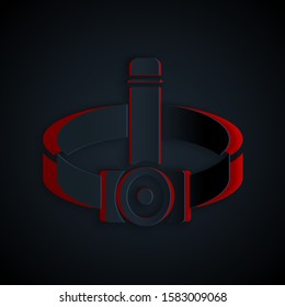 Paper cut Head flashlight icon isolated on black background. Tourist head flashlight. Camping head light. Paper art style. Vector Illustration