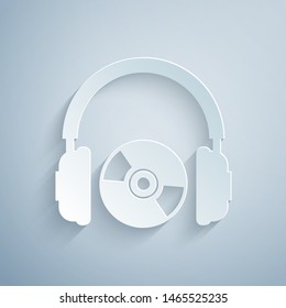 Paper cut Headphones and CD or DVD icon isolated on grey background. Earphone sign. Compact disk symbol. Paper art style. Vector Illustration