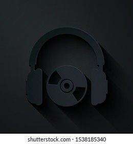 Paper cut Headphones and CD or DVD icon isolated on black background. Earphone sign. Compact disk symbol. Paper art style. Vector Illustration
