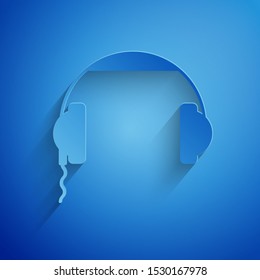 Paper cut Headphones icon isolated on blue background. Earphones sign. Concept for listening to music, service, communication and operator. Paper art style. Vector Illustration