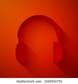 Paper cut Headphones icon isolated on red background. Earphones sign. Concept object for listening to music, service, communication and operator. Paper art style. Vector Illustration