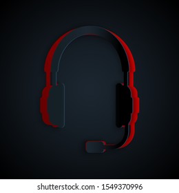 Paper cut Headphones with microphone icon isolated on black background. Concept object for listening to music, service, communication and operator. Paper art style. Vector Illustration