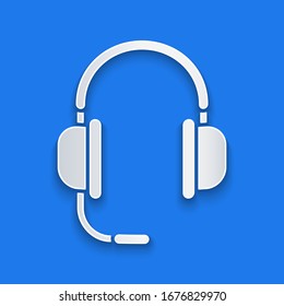 Paper cut Headphones with microphone icon isolated on blue background. Paper art style. Vector Illustration
