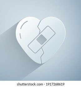 Paper cut Healed broken heart or divorce icon isolated on grey background. Shattered and patched heart. Love symbol. Valentines day. Paper art style. Vector