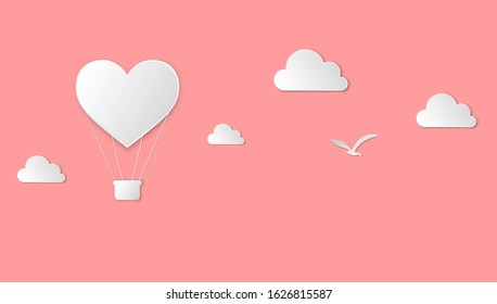 paper cut heart hot air balloon, clouds and bird on pink background. valentines day and love theme design. craft paper style