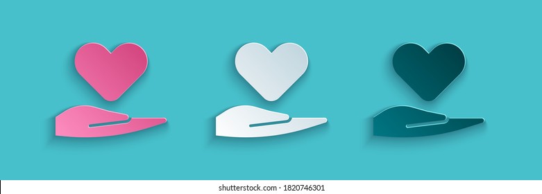 Paper Cut Heart On Hand Icon Isolated On Blue Background. Hand Giving Love Symbol. Valentines Day Symbol. Paper Art Style. Vector Illustration