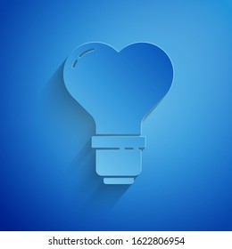 Paper cut Heart shape in a light bulb icon isolated on blue background. Love symbol. Valentine day symbol. Paper art style. Vector Illustration