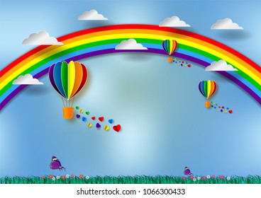 Paper cut heart shape with rainbow and balloons for LGBT or GLBT pride, or lesbian, gay, bisexual, transgender, on blue background