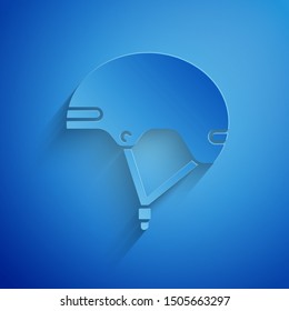 Paper cut Helmet icon isolated on blue background. Extreme sport. Sport equipment. Paper art style. Vector Illustration