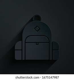 Paper cut Hiking backpack icon isolated on black background. Camping and mountain exploring backpack. Paper art style. Vector Illustration