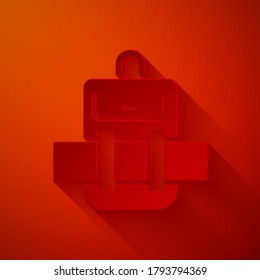 Paper cut Hiking backpack icon isolated on red background. Camping and mountain exploring backpack. Paper art style. Vector