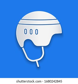 Paper cut Hockey helmet icon isolated on blue background. Paper art style. Vector Illustration