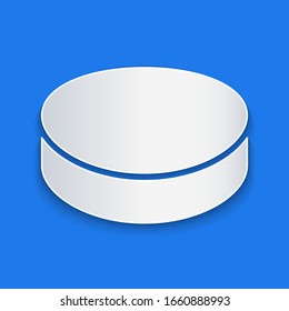 Paper cut Hockey puck icon isolated on blue background. Paper art style. Vector Illustration