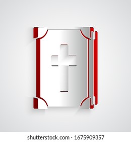 Paper cut Holy bible book icon isolated on grey background. Paper art style. Vector Illustration