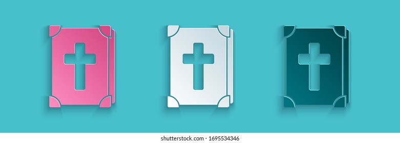 Paper cut Holy bible book icon isolated on blue background. Paper art style. Vector Illustration