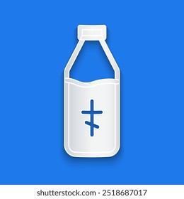 Paper cut Holy water bottle icon isolated on blue background. Glass flask with magic liquid. Paper art style. Vector