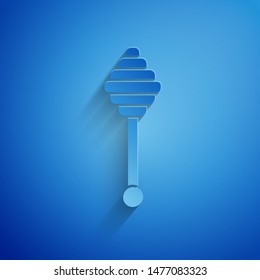 Paper cut Honey dipper stick icon isolated on blue background. Honey ladle. Paper art style. Vector Illustration