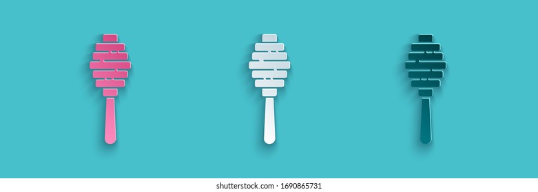 Paper cut Honey dipper stick icon isolated on blue background. Honey ladle. Paper art style. Vector Illustration
