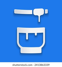 Paper cut Honey dipper stick and bowl icon isolated on blue background. Honey ladle. Paper art style. Vector Illustration