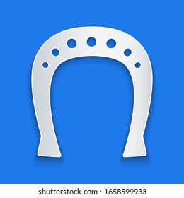 Paper cut Horseshoe icon isolated on blue background. Paper art style. Vector Illustration