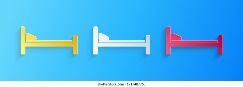 Paper cut Hospital Bed icon isolated on blue background. Paper art style. Vector.