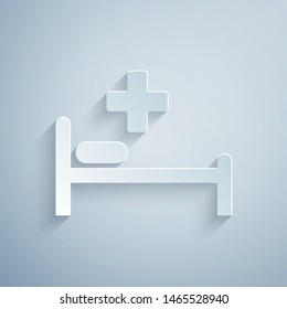 Paper cut Hospital Bed with Medical symbol of the Emergency - Star of Life icon isolated on grey background. Paper art style. Vector Illustration