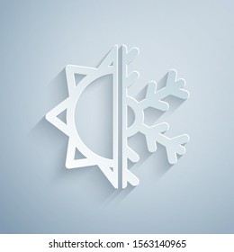 Paper cut Hot and cold symbol. Sun and snowflake icon isolated on grey background. Winter and summer symbol. Paper art style. Vector Illustration