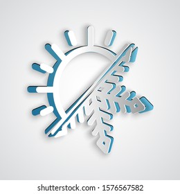 Paper cut Hot and cold symbol. Sun and snowflake icon isolated on grey background. Winter and summer symbol. Paper art style. Vector Illustration
