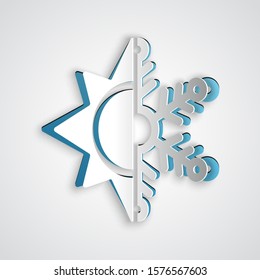 Paper cut Hot and cold symbol. Sun and snowflake icon isolated on grey background. Winter and summer symbol. Paper art style. Vector Illustration