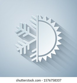 Paper cut Hot and cold symbol. Sun and snowflake icon isolated on grey background. Winter and summer symbol. Paper art style. Vector Illustration