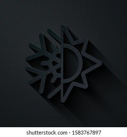 Paper cut Hot and cold symbol. Sun and snowflake icon isolated on black background. Winter and summer symbol. Paper art style. Vector Illustration