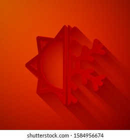 Paper cut Hot and cold symbol. Sun and snowflake icon isolated on red background. Winter and summer symbol. Paper art style. Vector Illustration