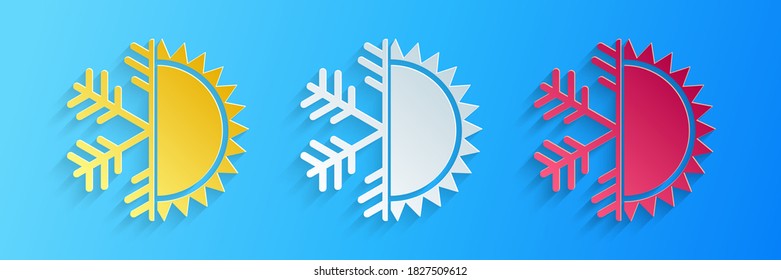 Paper cut Hot and cold symbol. Sun and snowflake icon isolated on blue background. Winter and summer symbol. Paper art style. Vector.